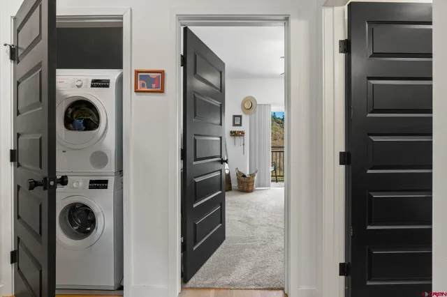 a view of a storage and utility room with washer and dryer