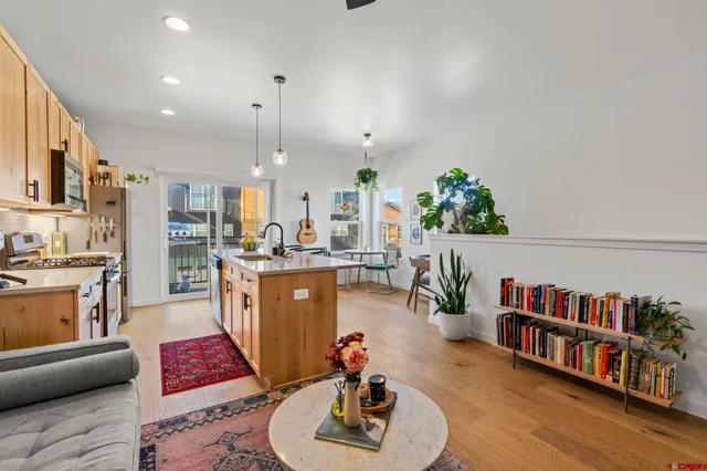 a living room with furniture and a book shelf