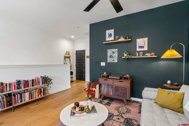 a living room with furniture and a book shelf