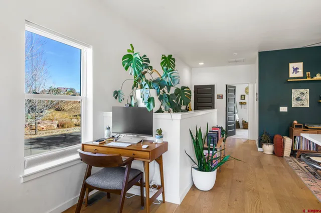a work room with furniture and a potted plant