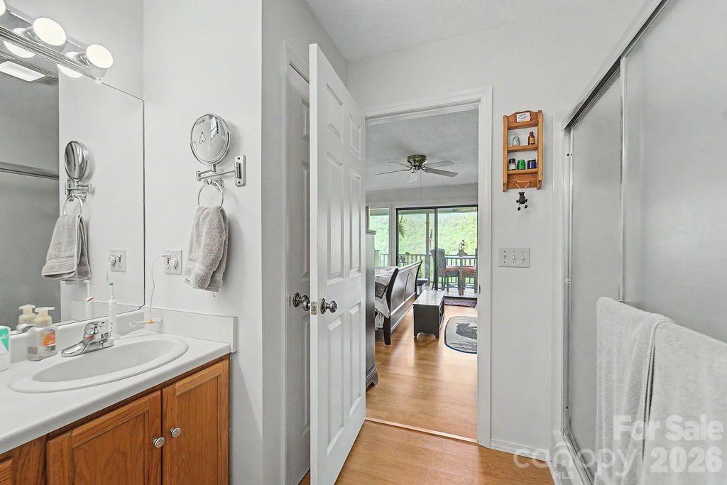 531 Reserve Road Franklin, NC 28734 - Photo 21 of 41 a en suite bathroom with a granite countertop sink and a mirror