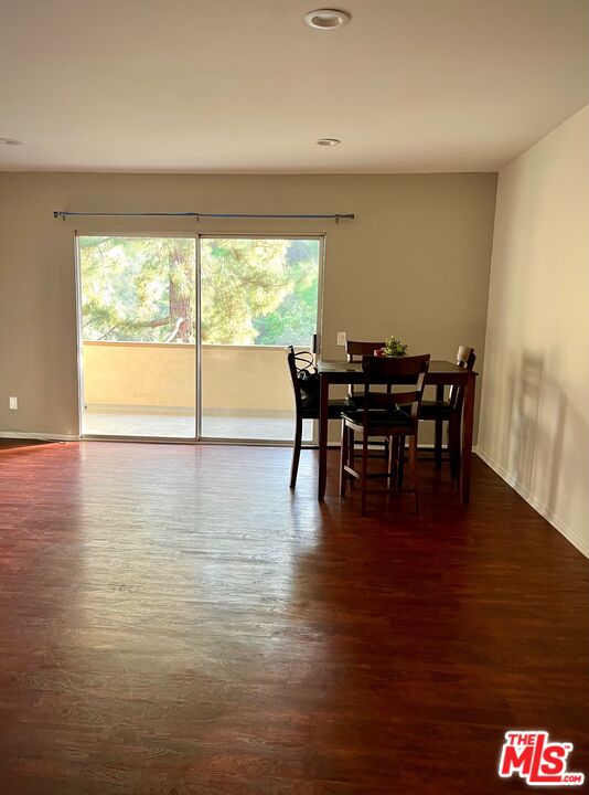 1935 Alpha Road, Unit 114 Glendale, CA 91208 - Photo 4 of 12 a view of a dining room with furniture and wooden floor