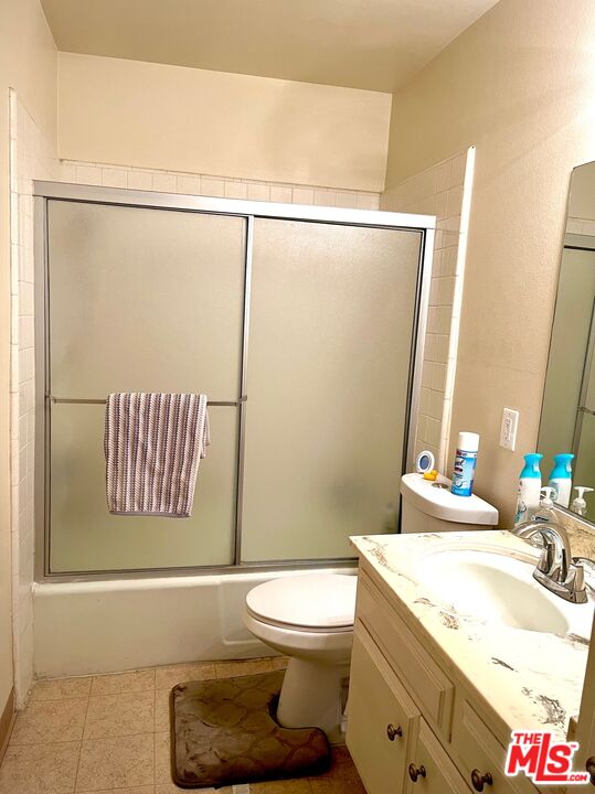 1935 Alpha Road, Unit 114 Glendale, CA 91208 - Photo 10 of 12 a bathroom with a granite countertop sink mirror vanity and toilet