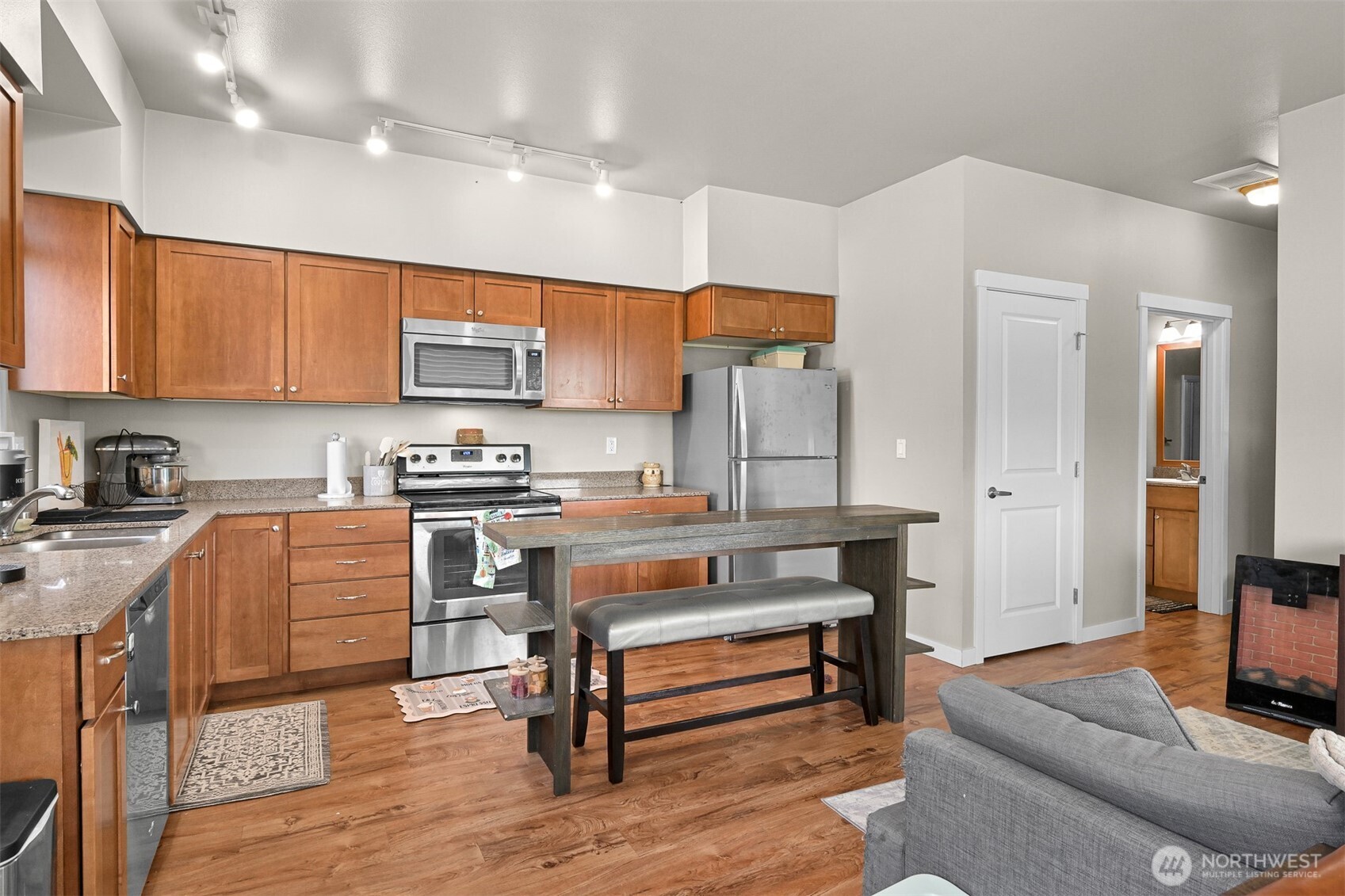 8844 Depot Road, Unit B211 Lynden, WA 98264 - Photo 11 of 29 a kitchen with a refrigerator a stove and a sink with wooden floor