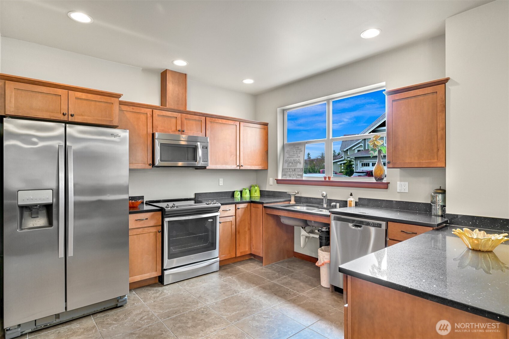 8844 Depot Road, Unit B211 Lynden, WA 98264 - Photo 20 of 29 a kitchen with stainless steel appliances granite countertop a sink a stove a refrigerator cabinets and a window