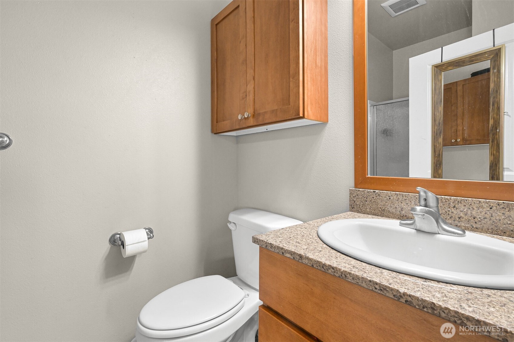 8844 Depot Road, Unit B211 Lynden, WA 98264 - Photo 4 of 29 a bathroom with a granite countertop toilet sink and mirror