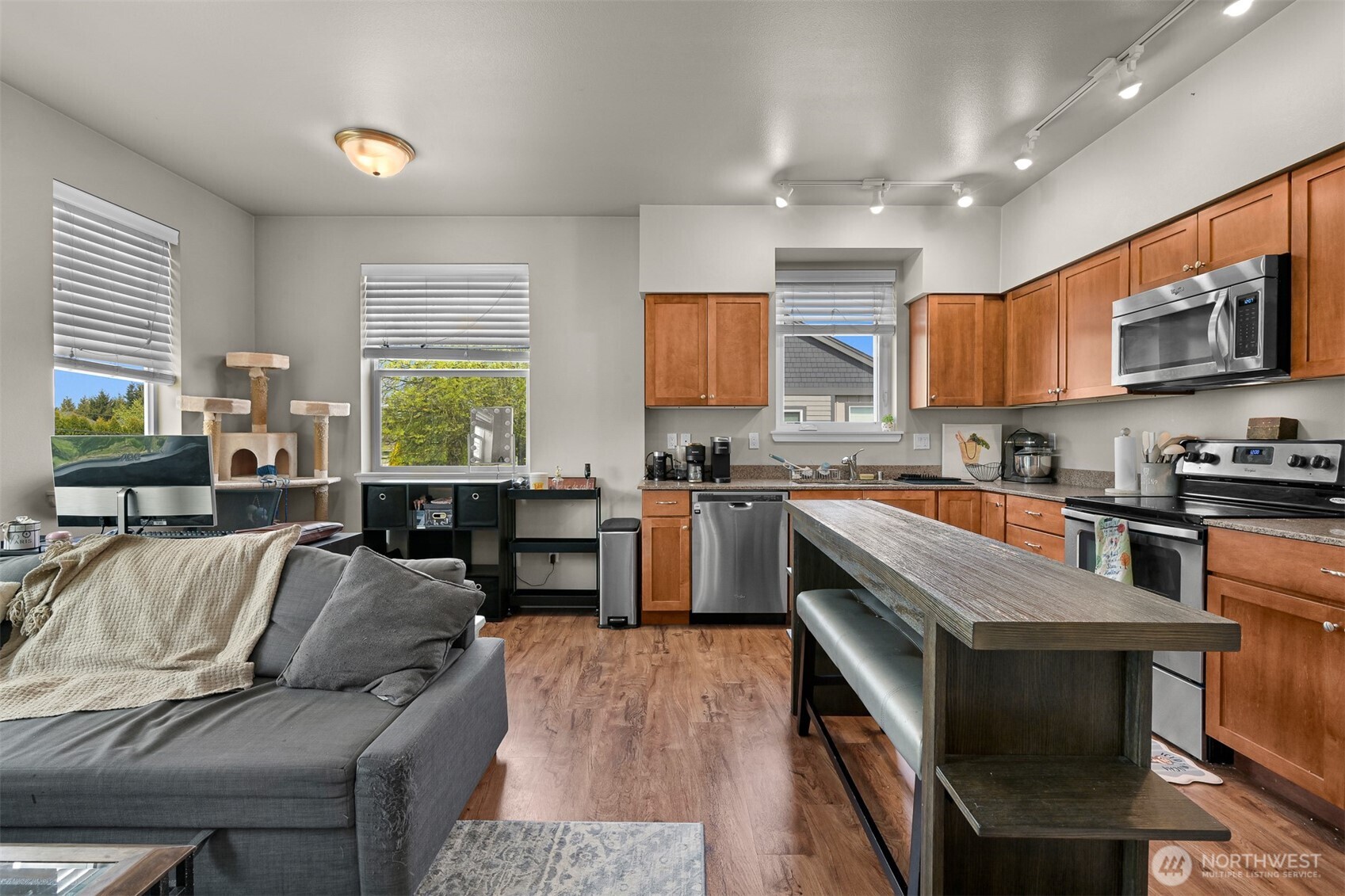 8844 Depot Road, Unit B211 Lynden, WA 98264 - Photo 8 of 29 a kitchen with stainless steel appliances granite countertop a stove top oven a sink dishwasher a dining table and chairs with wooden floor