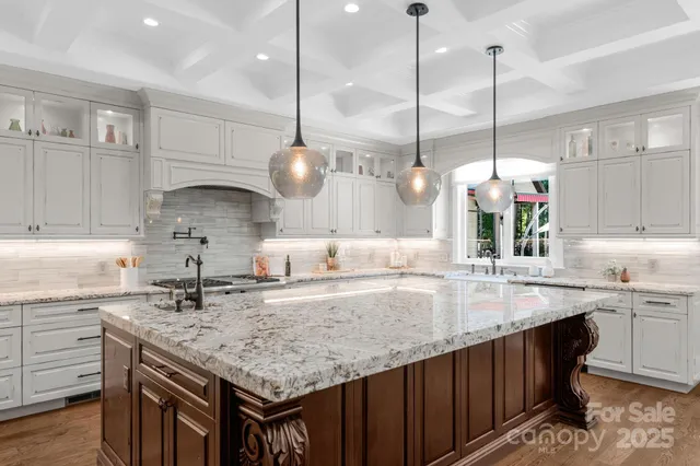 a kitchen with a sink a center island cabinets and wooden floor