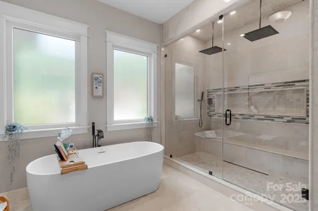 a bathroom with a tub a sink and shower