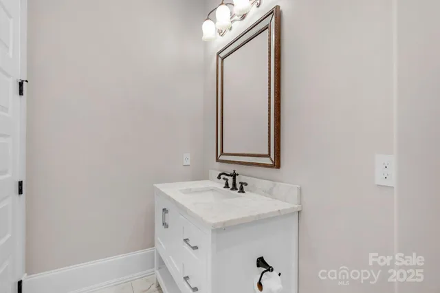 a bathroom with a sink a vanity and a mirror
