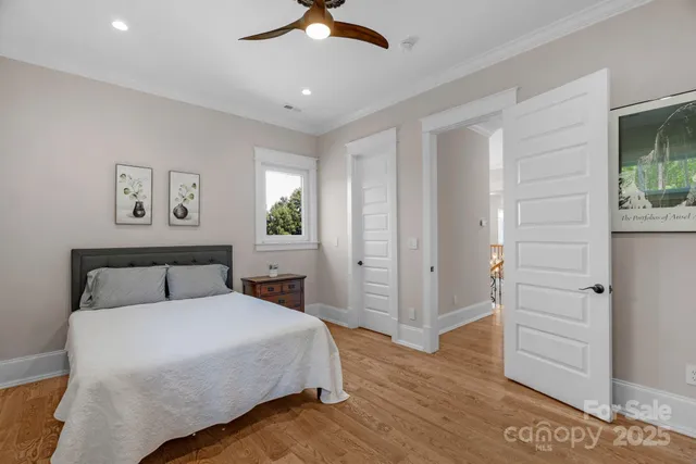 a bedroom with a bed and a painting on the wall