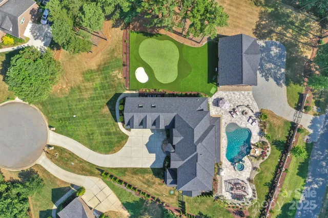 an aerial view of a house with a garden and trees