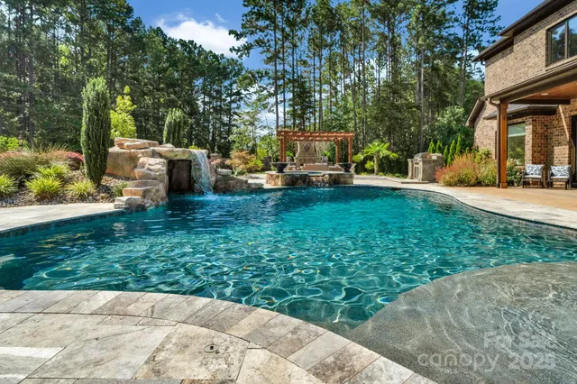 a view of a patio with table and chairs potted plants and large tree
