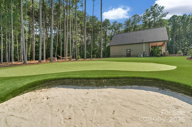 a front view of a house with a yard and trees