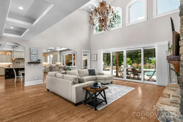 a living room with furniture and a floor to ceiling window