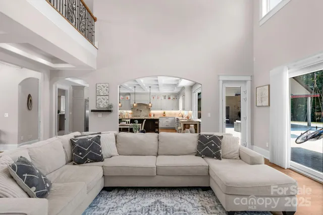 a living room with furniture and a chandelier