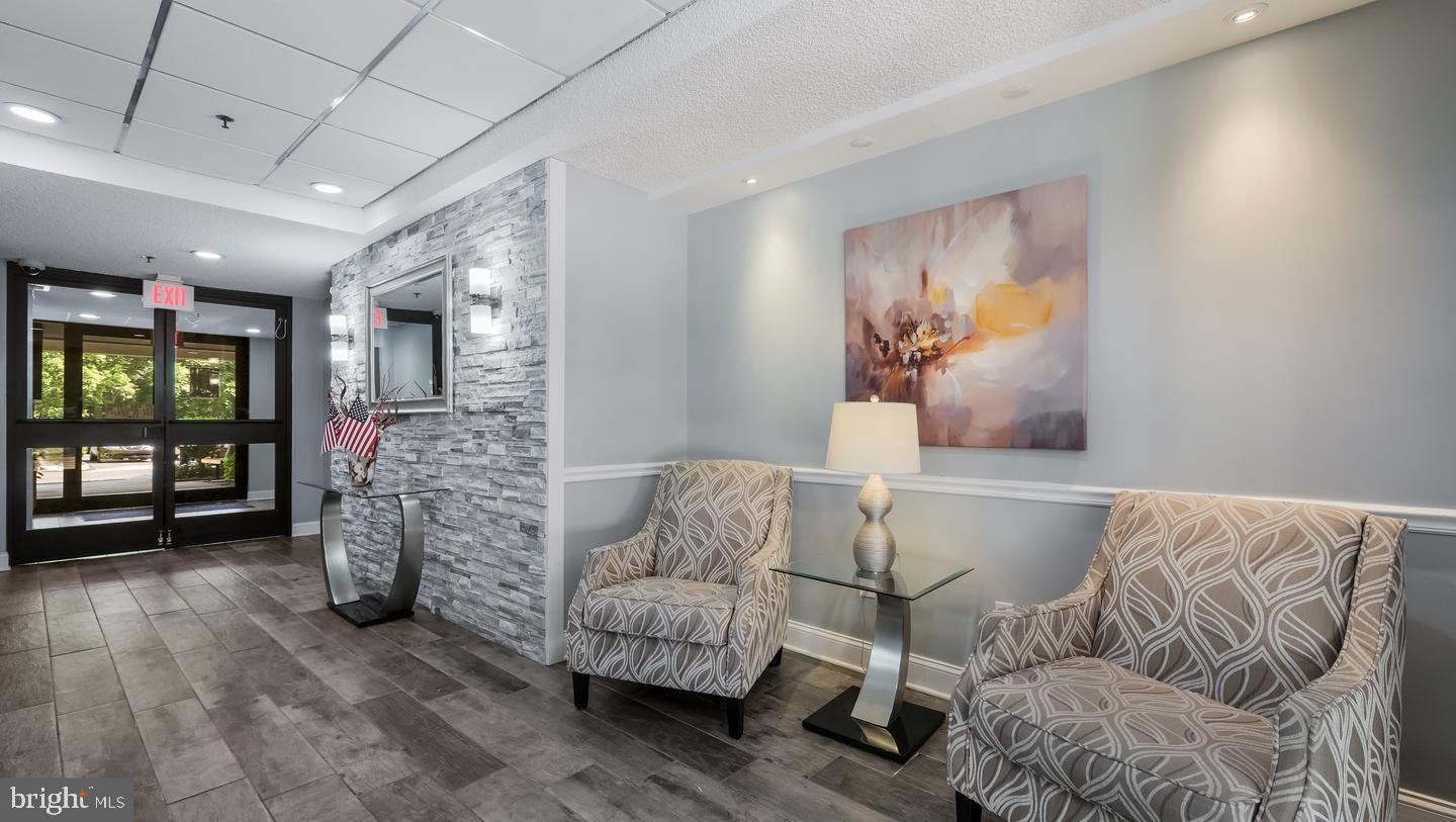 800 Avondale Road, Unit 6C Wallingford, PA 19086 - Photo 3 of 25 a living room with furniture and a floor to ceiling window