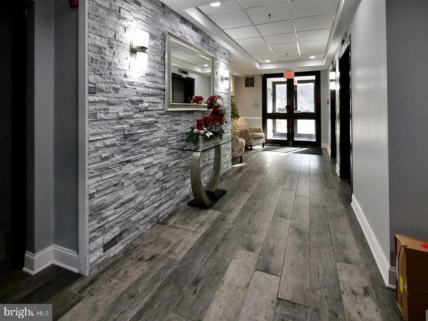800 Avondale Road, Unit 6C Wallingford, PA 19086 - Photo 4 of 25 a hallway with a stove oven and a kitchen view