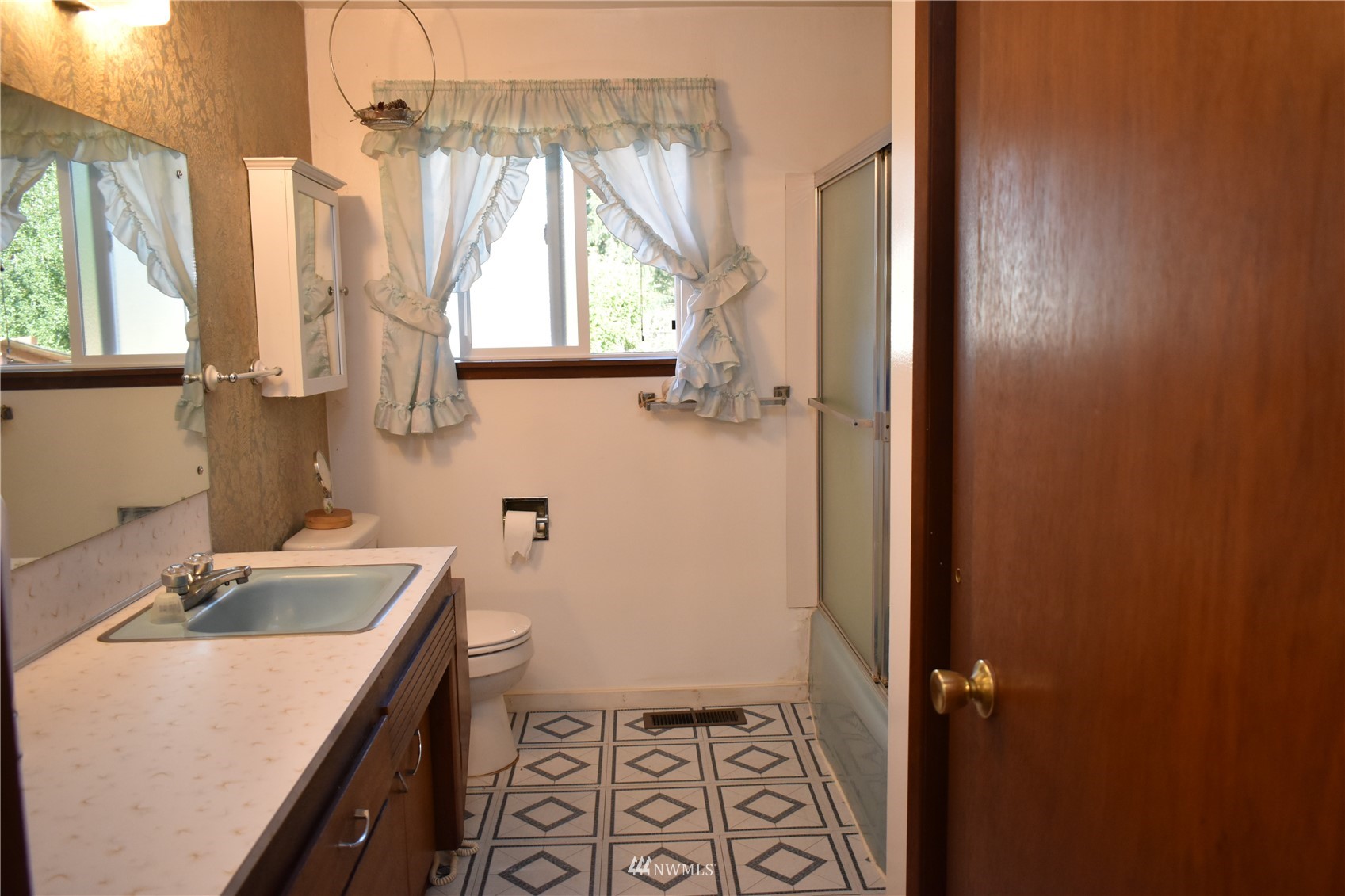 819 Sheridan Road Bremerton, WA 98310 - Photo 12 of 40 a bathroom with a sink a toilet and a window