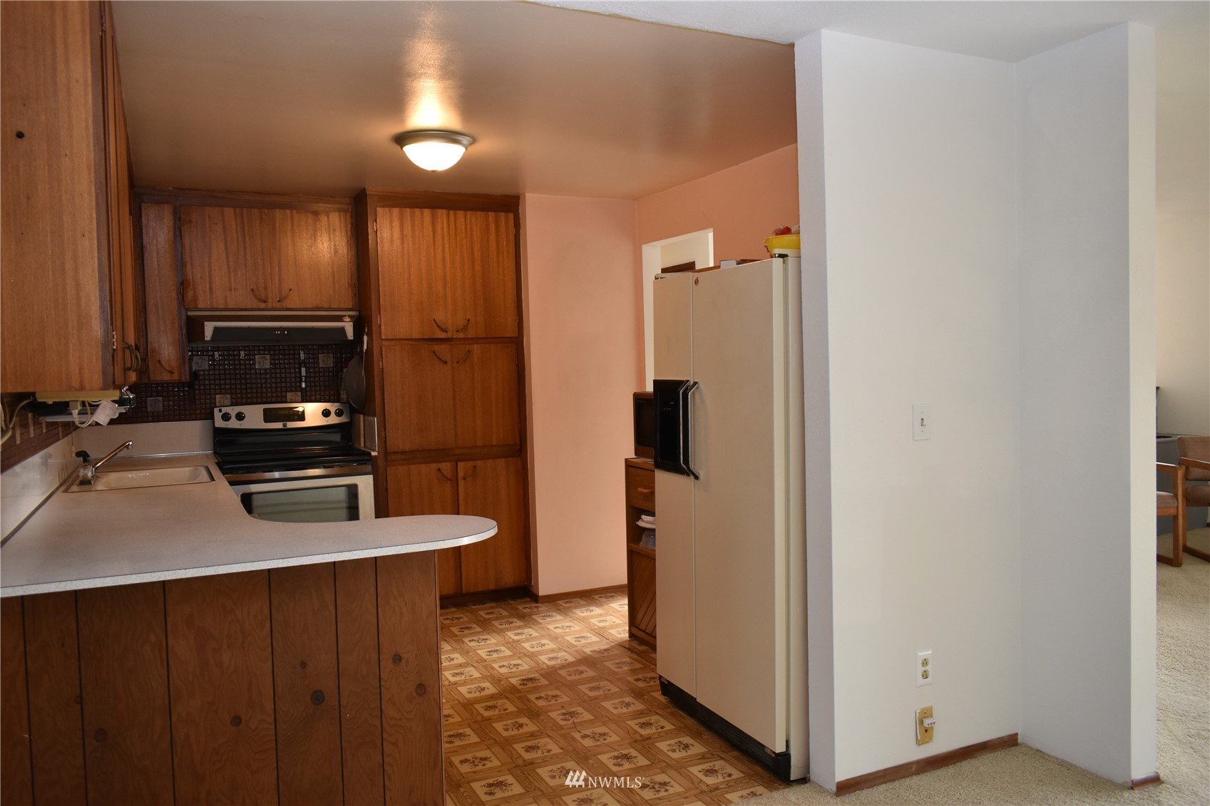 819 Sheridan Road Bremerton, WA 98310 - Photo 7 of 40 a kitchen with stainless steel appliances a refrigerator and a stove top oven