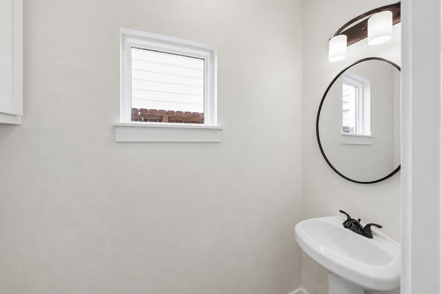2749 Redrock Street, Unit B Houston, TX 77088 - Photo 11 of 24 The half bathroom is convenietly located on the first floor for guests. Included is a pedestal sink with mirror & lighting above.