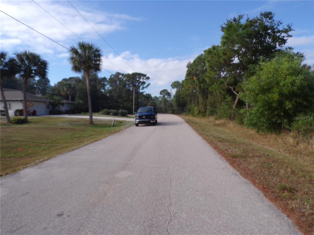 12069 Borax Avenue Punta Gorda, FL 33955 - Photo 8 of 10 a view of a road with a yard
