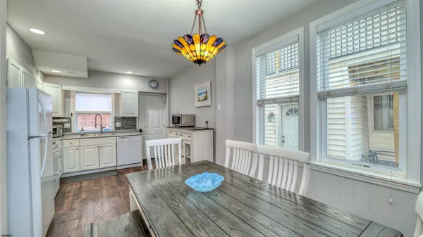 a kitchen with sink refrigerator and large window