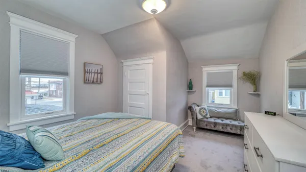 a bedroom with a bed couch and window