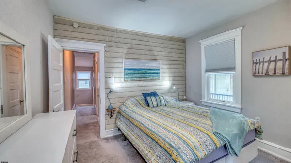 a spacious bedroom with a bed and a window