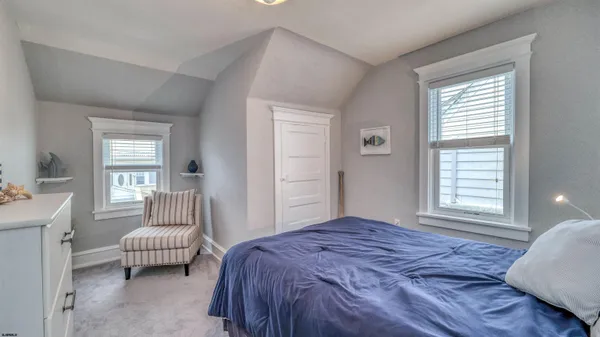 a bedroom with a bed and a couch