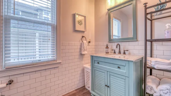 a bathroom with a sink vanity and a mirror