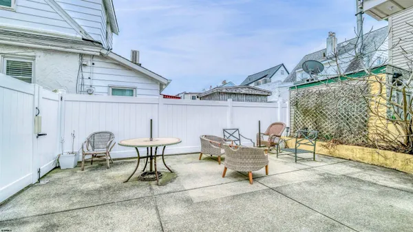 a view of a patio with a table and chairs