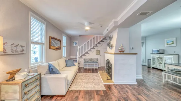 a living room with furniture and a wooden floor