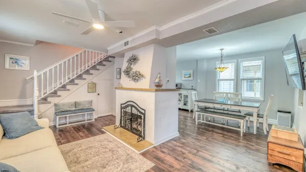 a view of entryway kitchen and hall with wooden floor