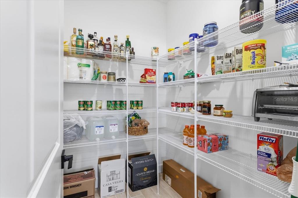 1054 Southwest 67th Street Gainesville, FL 32607 - Photo 12 of 37 a room with a fridge and a wooden floor