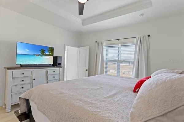 a bedroom with a bed and a flat screen tv
