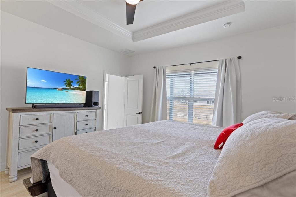 1054 Southwest 67th Street Gainesville, FL 32607 - Photo 16 of 37 a bedroom with a bed and a flat screen tv