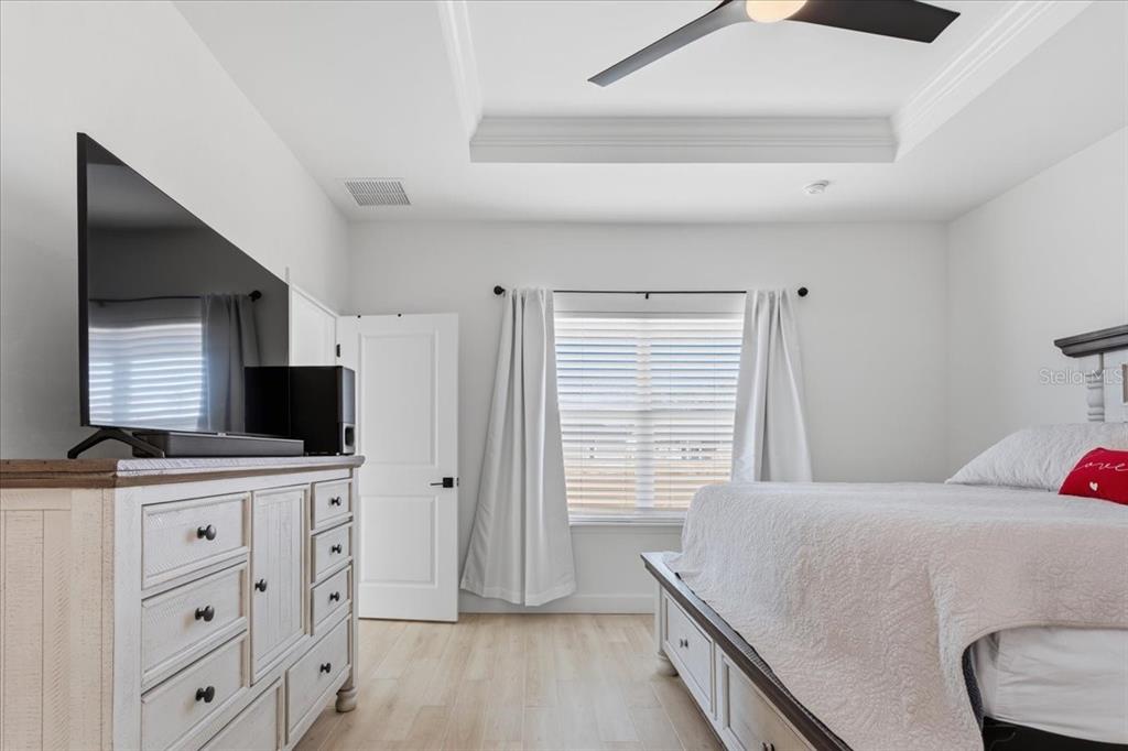 1054 Southwest 67th Street Gainesville, FL 32607 - Photo 17 of 37 a bedroom with a bed and a flat screen tv