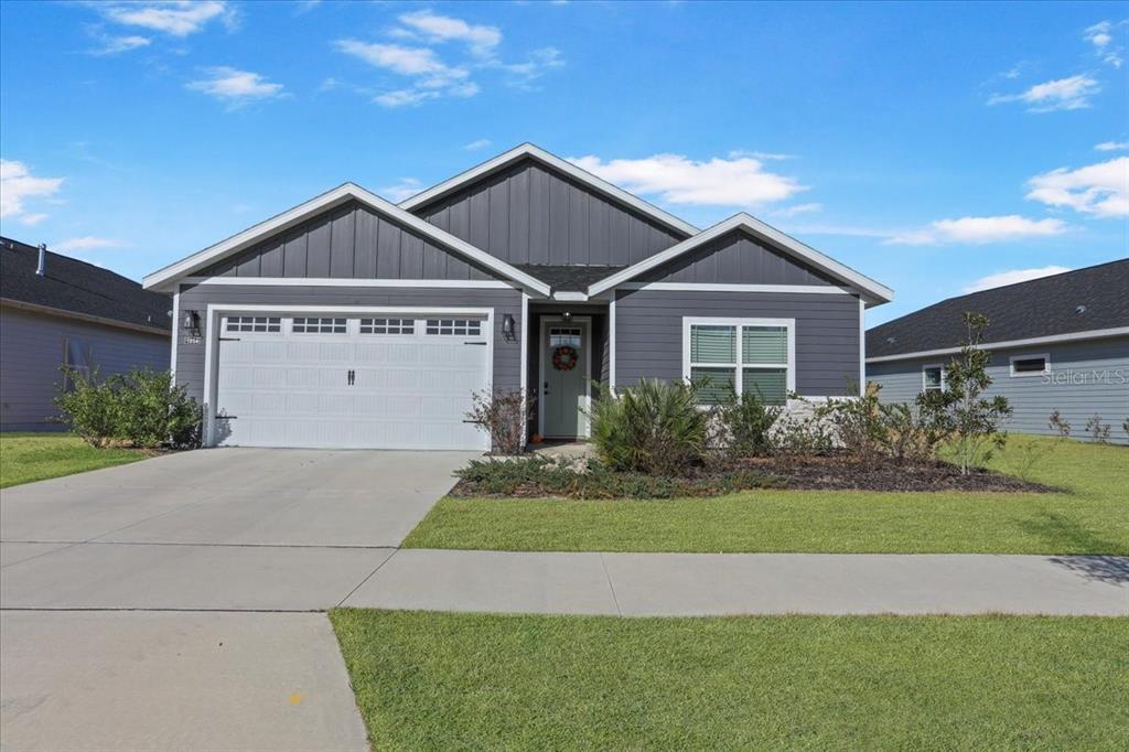 1054 Southwest 67th Street Gainesville, FL 32607 - Photo 2 of 37 a front view of a house with a yard