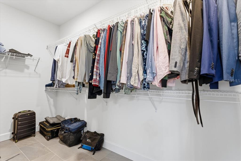 1054 Southwest 67th Street Gainesville, FL 32607 - Photo 21 of 37 a view of walk in closet with clothes