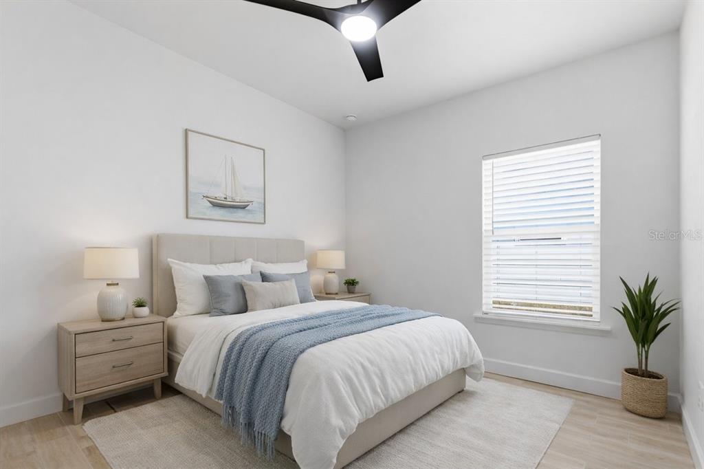 1054 Southwest 67th Street Gainesville, FL 32607 - Photo 24 of 37 a bedroom with a large bed and a potted plant