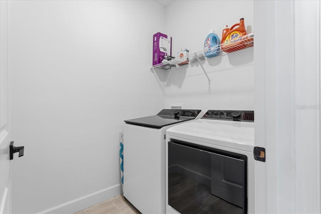 1054 Southwest 67th Street Gainesville, FL 32607 - Photo 26 of 37 a utility room with dryer and washer