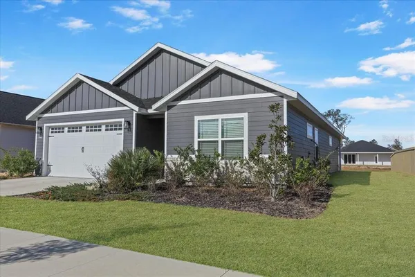 a front view of a house with a yard
