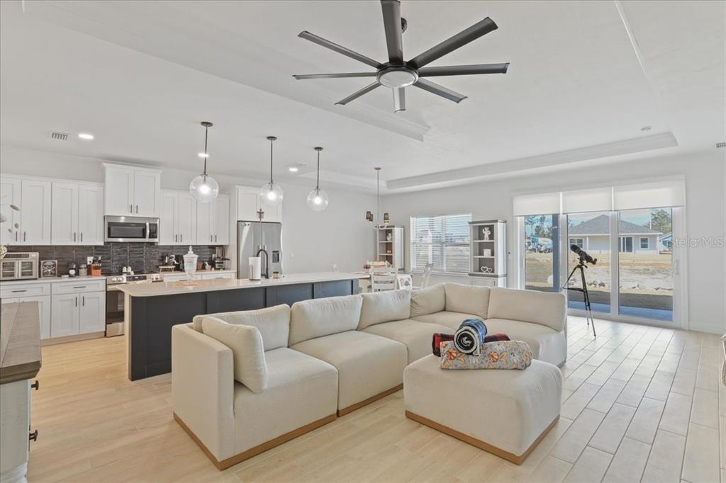 1054 Southwest 67th Street Gainesville, FL 32607 - Photo 4 of 37 a living room with furniture and a view of kitchen