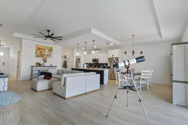 a living room with lots of furniture and kitchen view