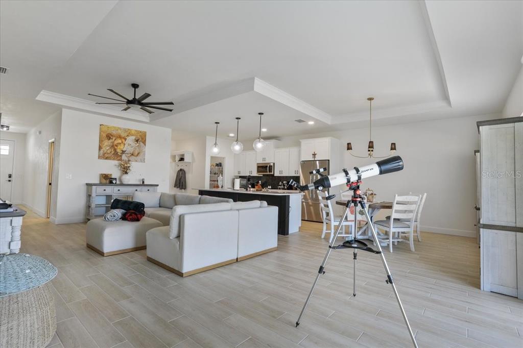 1054 Southwest 67th Street Gainesville, FL 32607 - Photo 6 of 37 a living room with lots of furniture and kitchen view