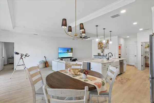 a large kitchen with a table and chairs