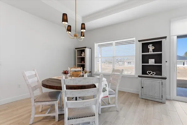 a view of a dining room with furniture and window