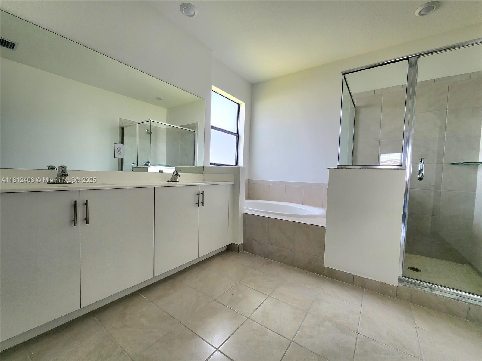 12959 Southwest 229th Lane Miami, FL 33170 - Photo 18 of 28 a bathroom with a tub sink and mirror