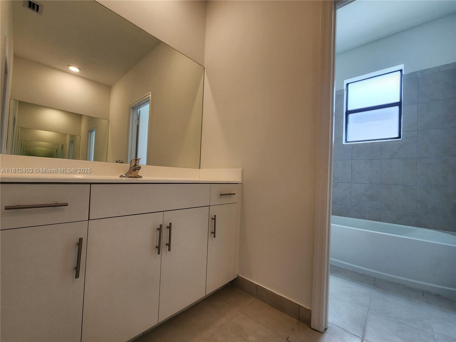 12959 Southwest 229th Lane Miami, FL 33170 - Photo 22 of 28 a bathroom with a sink and a mirror